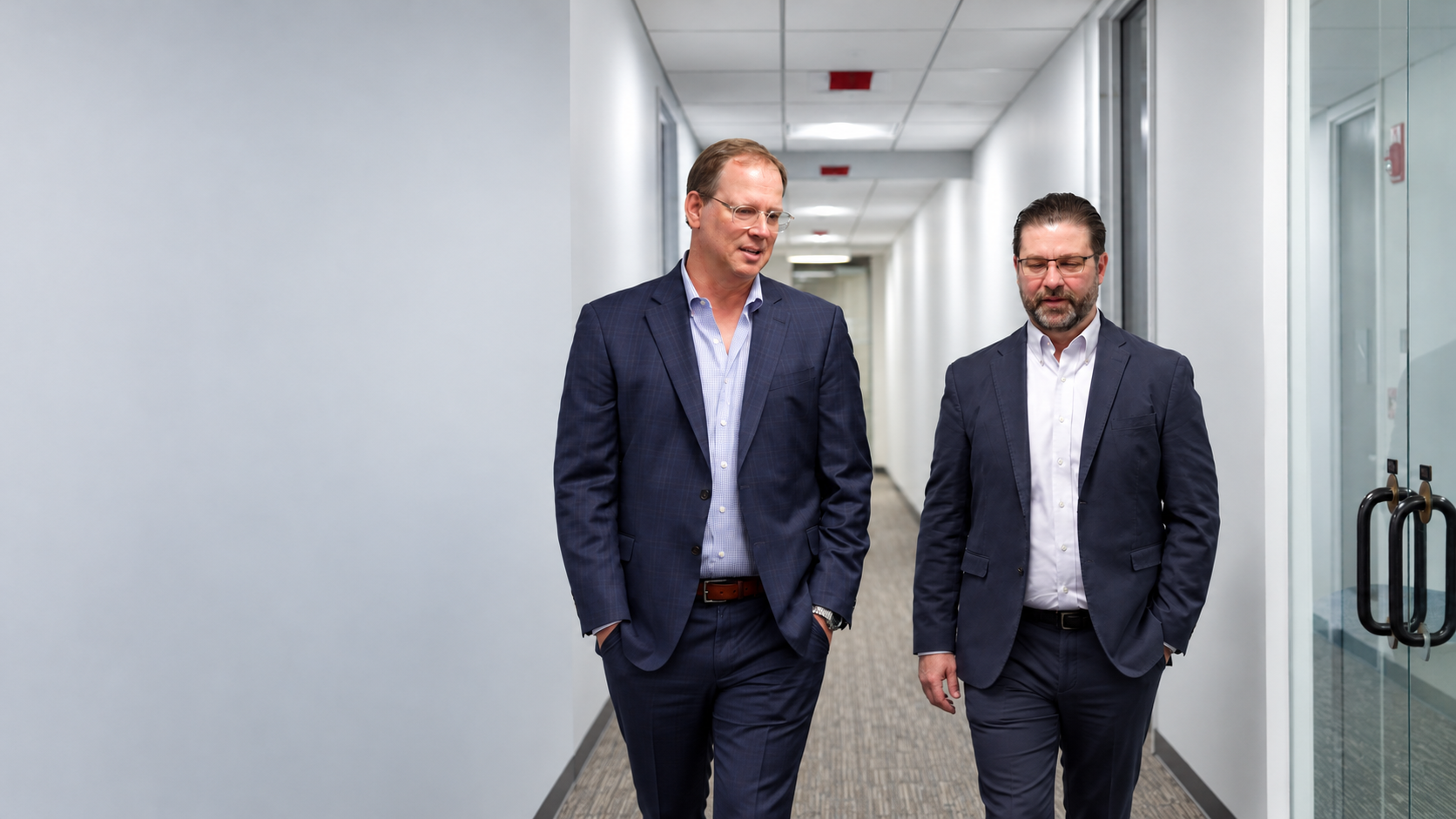 Colleagues walking through a modern hallway
